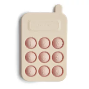 Mushie pukkasztós játék telefon - púderrózsaszín