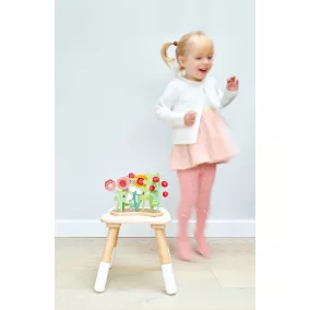 Virágágyás virágokkal és locsolókannával